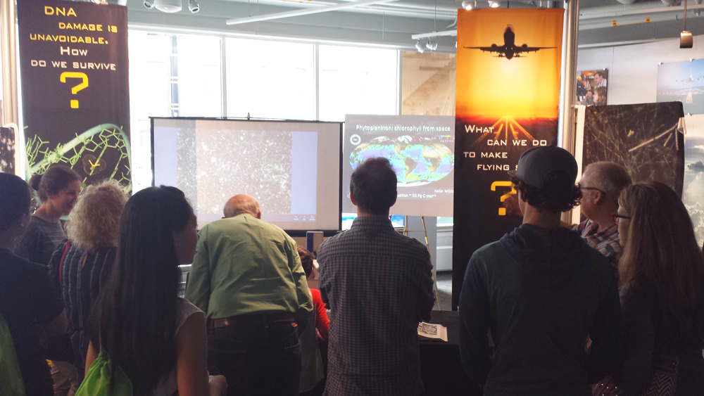 Earth Day visitors look on as MIT' Mick Follows discusses marine ecosystem interactions. (Credit: Lauren Hinkel)