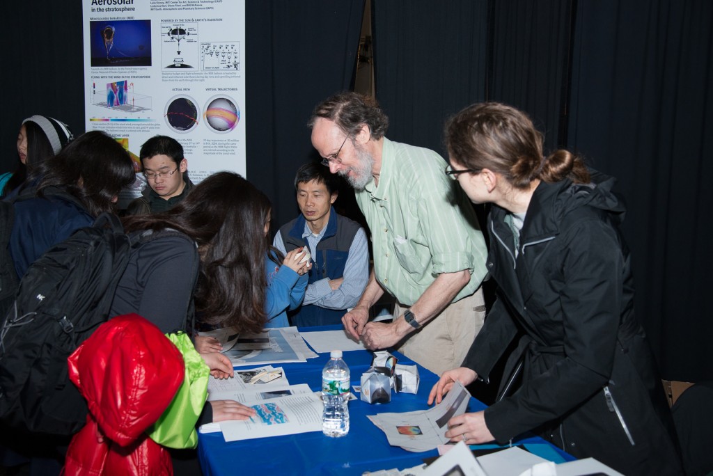 EAPS Professor of oceanography Glenn R. Flierl, graduate student Madeleine Youngs and Open House guests fold origami balloons, representing the Aerocene project and the atmospheric winds that keep them afloat. (Image: Vicki S McKenna)